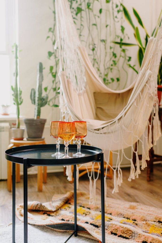 bright glasses with champagne on table in modern living room