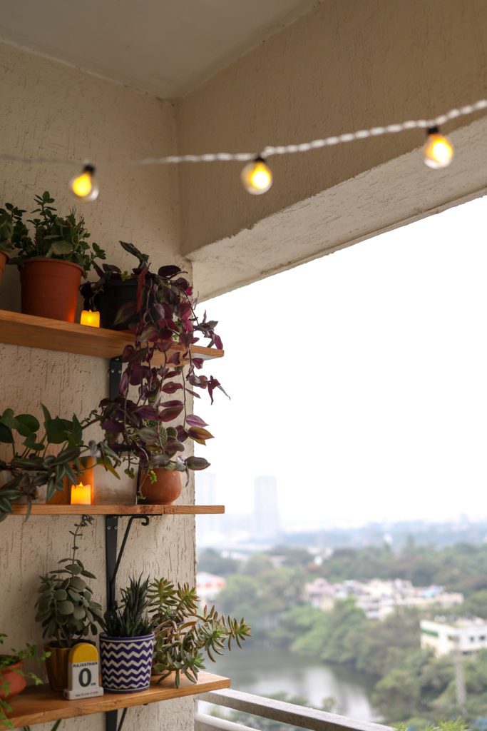 Vertical balcony garden with LED String Lights in small space balcony 