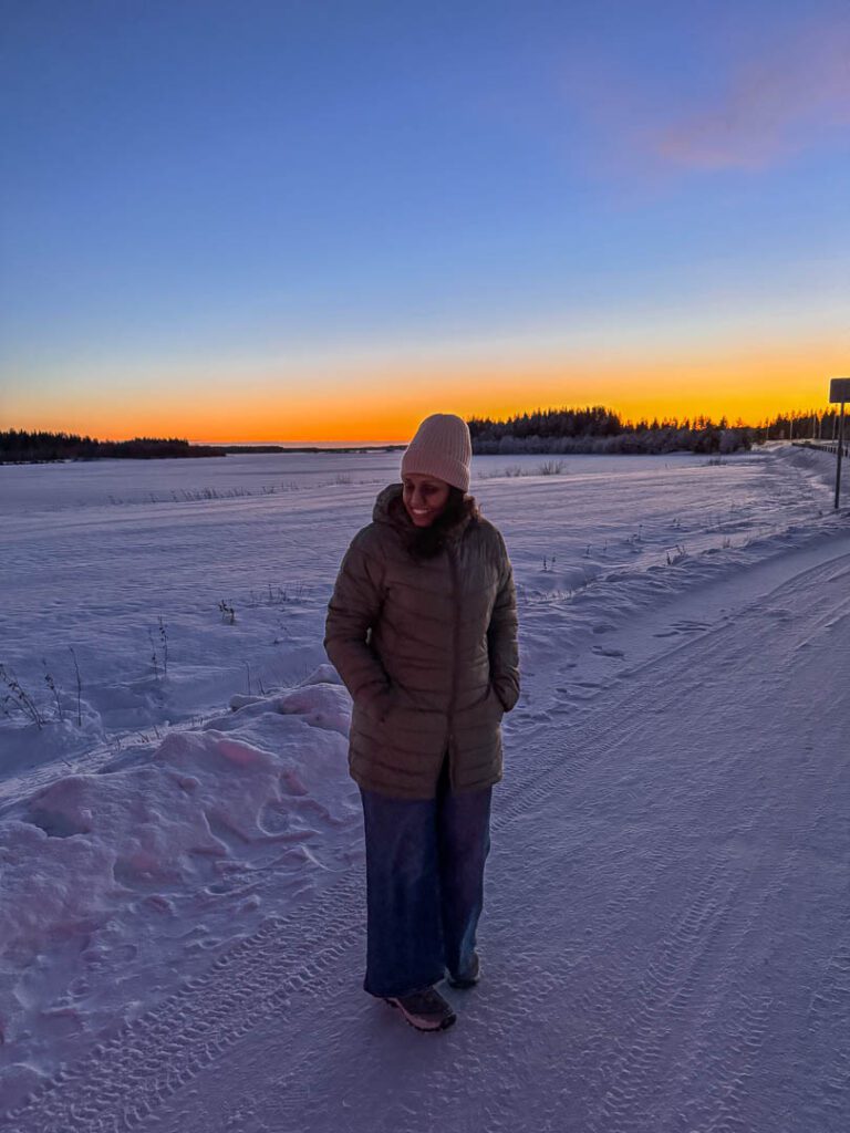 Girl standing on Frozen lake in the arctic finnish lapland